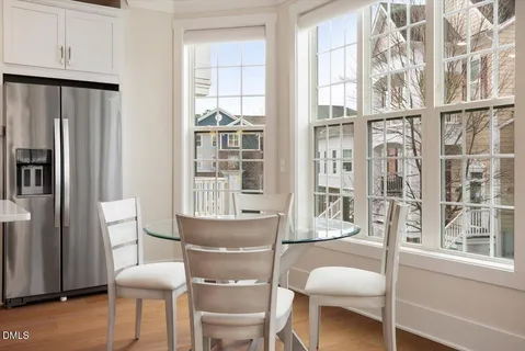 a dining room with furniture and a window