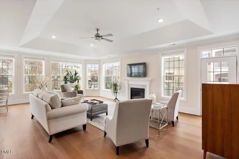 a living room with furniture a fireplace and a table