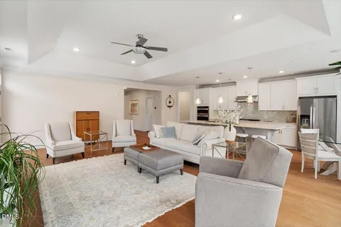 a living room with furniture and kitchen view