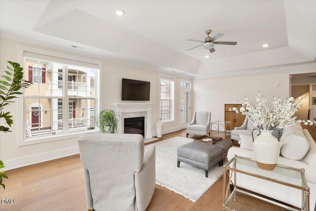 10530 Sablewood Drive, Unit 215 Raleigh, NC 27617 - Photo 23 of 40 a living room with furniture a fireplace and a flat screen tv