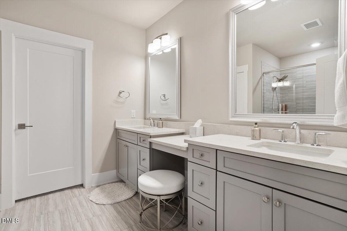 10530 Sablewood Drive, Unit 215 Raleigh, NC 27617 - Photo 29 of 40 a bathroom with a toilet a sink and mirror
