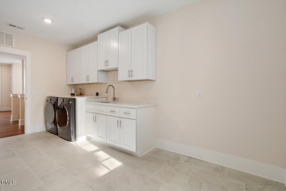 10530 Sablewood Drive, Unit 215 Raleigh, NC 27617 - Photo 32 of 40 a utility room with cabinets washer and dryer