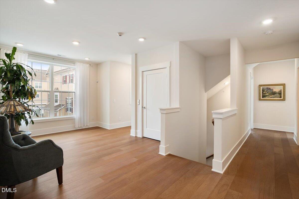 10530 Sablewood Drive, Unit 215 Raleigh, NC 27617 - Photo 6 of 40 a view of an empty room with a window and wooden floor