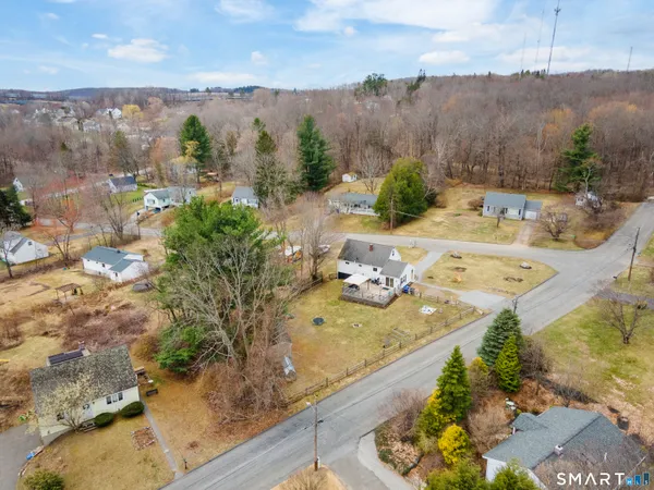 an aerial view of a house with a yard and lake view