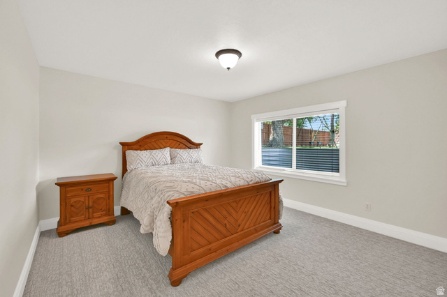 13658 South Fort Street Draper, UT 84020 - Photo 40 of 87 Carpeted room featuring a single window with blinds, white trim, and a ceiling-mounted light fixture