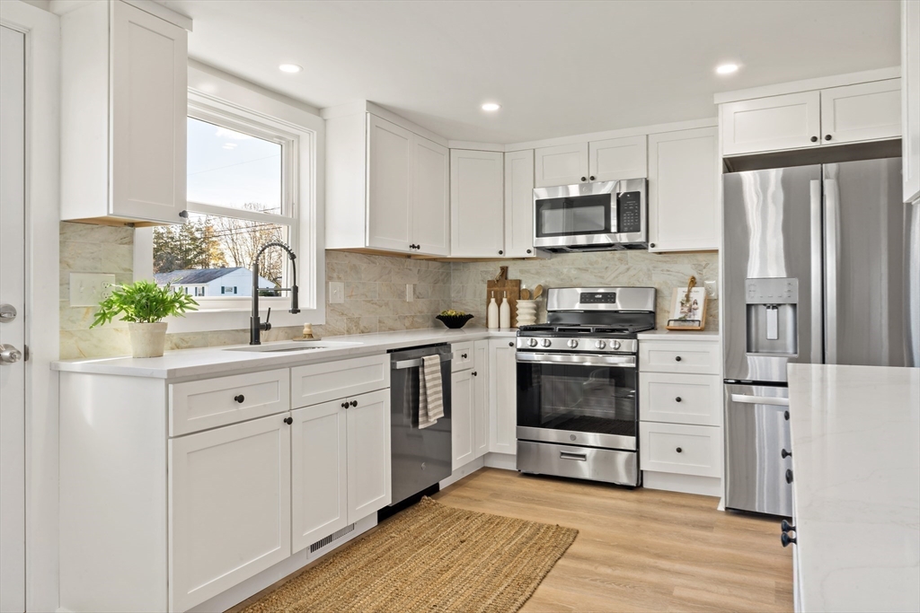 602 Regan Road Somerset, MA 02726 - Photo 12 of 35 a kitchen with stainless steel appliances white cabinets and a sink