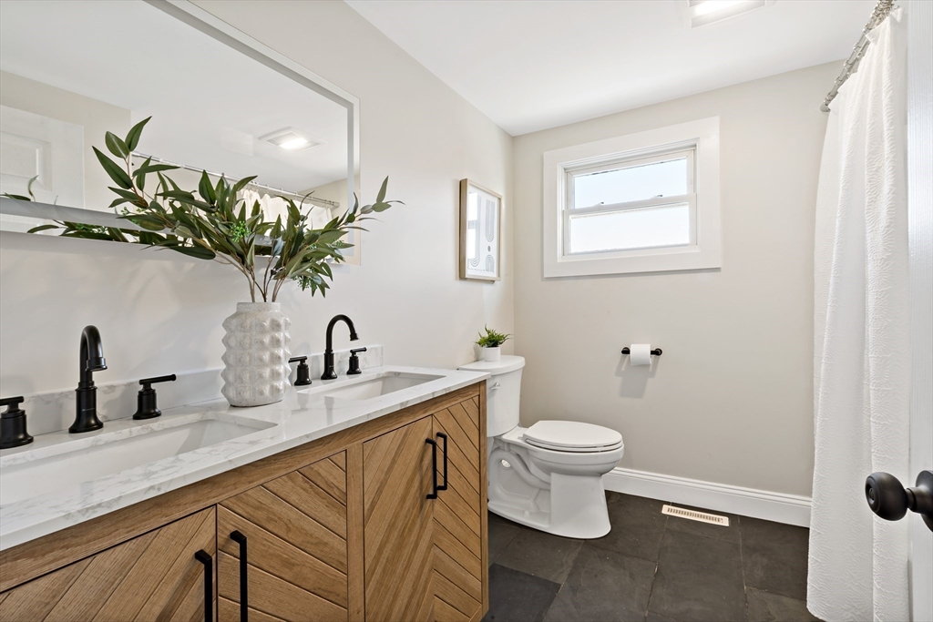 602 Regan Road Somerset, MA 02726 - Photo 19 of 35 a bathroom with a toilet sink and mirror
