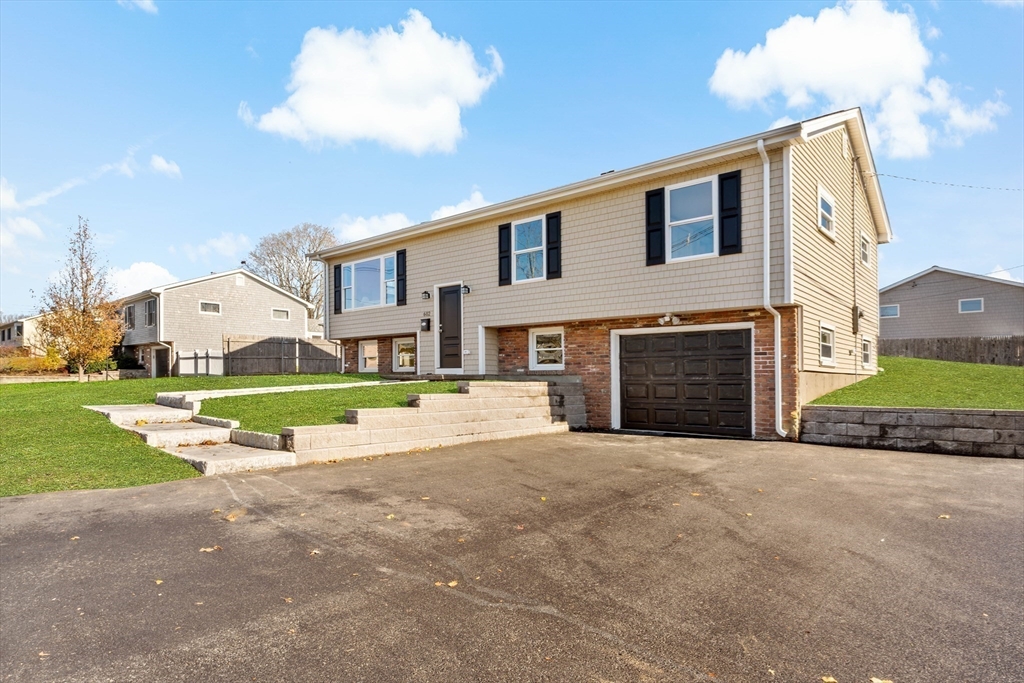 602 Regan Road Somerset, MA 02726 - Photo 2 of 35 a view of a house with a big yard and a large tree