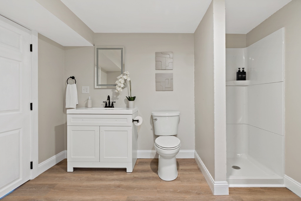 602 Regan Road Somerset, MA 02726 - Photo 29 of 35 a bathroom with a toilet sink a mirror and shower