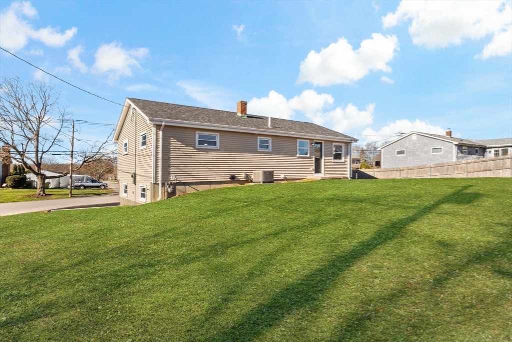 602 Regan Road Somerset, MA 02726 - Photo 32 of 35 a view of a house with a big yard and large trees