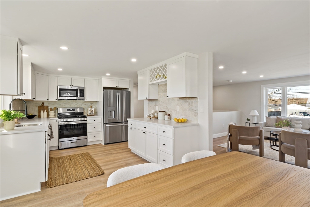 602 Regan Road Somerset, MA 02726 - Photo 9 of 35 a kitchen with cabinets wooden floor and stainless steel appliances