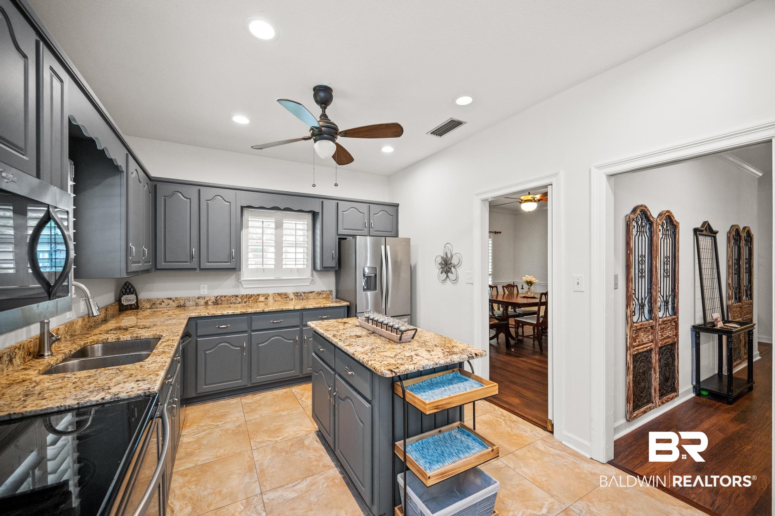 6638 Jackson Square Daphne, AL 36526 - Photo 10 of 62 Kitchen featuring light tile patterned floors, a center island, ceiling fan, and stainless steel appliances