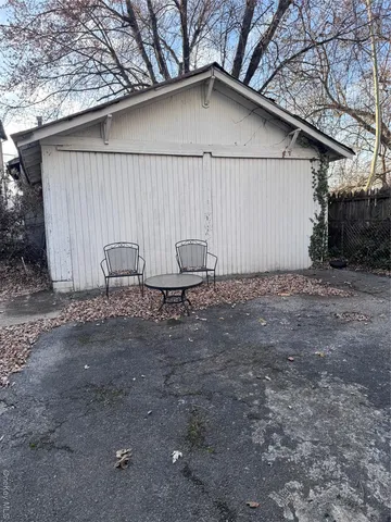a backyard of a house with table and chairs