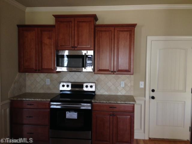 245 Raspberry Ridge Drive Clemmons, NC 27012 - Photo 3 of 16 Kitchen. Stainless Appliances, Tile Back Splash