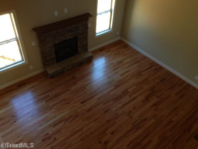 245 Raspberry Ridge Drive Clemmons, NC 27012 - Photo 8 of 16 Living Room. Stone Gas Log Fireplace, Hardwoods