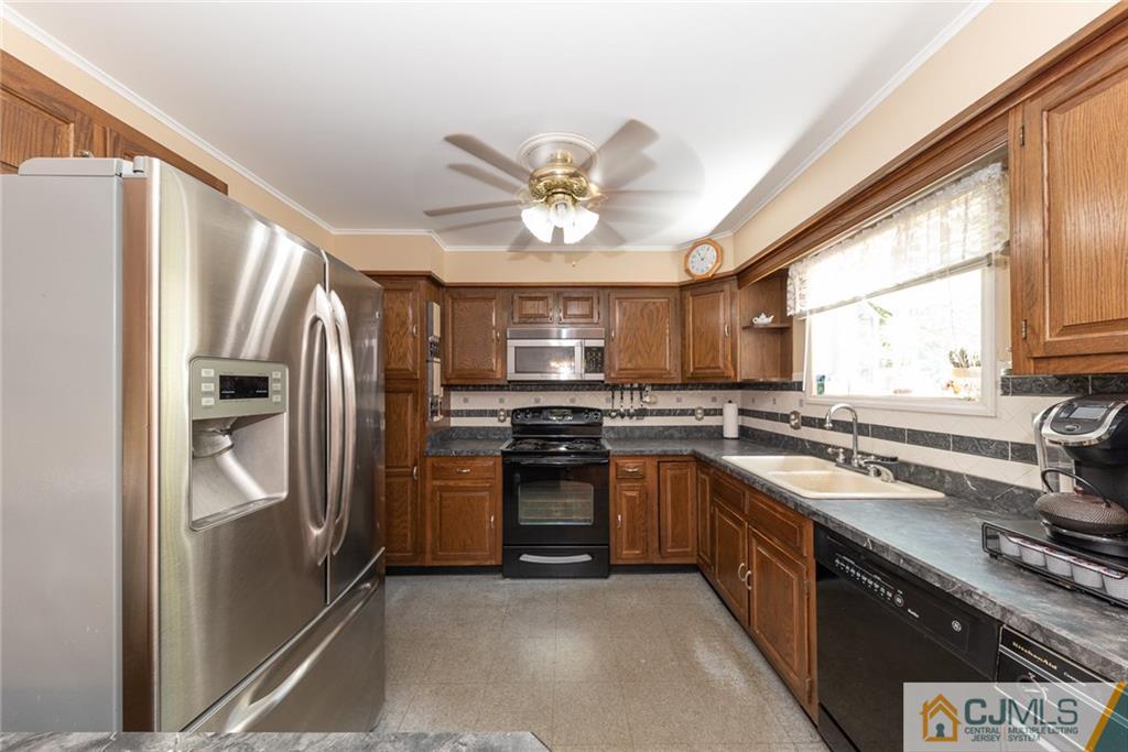 195 North New Prospect Road Jackson, NJ 08527 - Photo 8 of 25 a kitchen with stainless steel appliances granite countertop a stove a refrigerator and a sink
