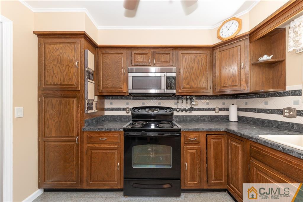 195 North New Prospect Road Jackson, NJ 08527 - Photo 10 of 25 a kitchen with a stove and a microwave
