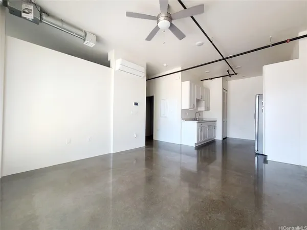 a view of empty room with wooden floor and windows