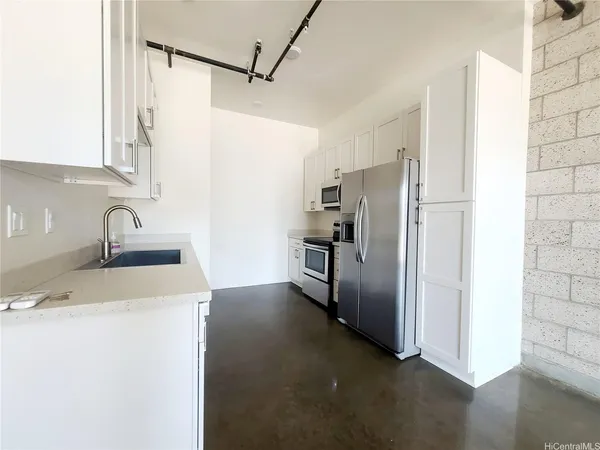 a kitchen with stainless steel appliances a refrigerator and a sink