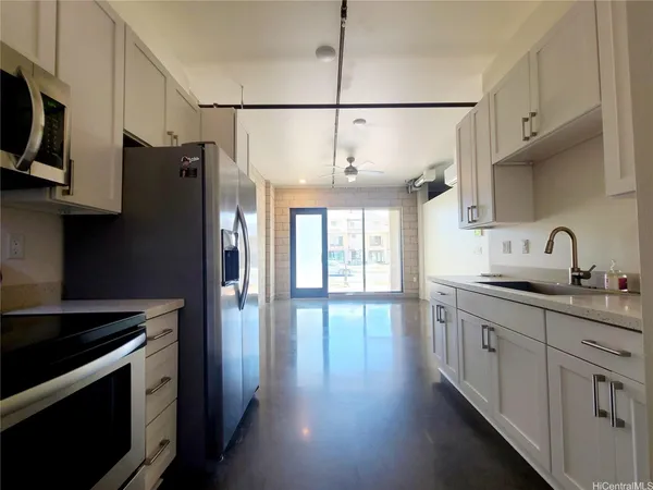 a kitchen with stainless steel appliances a sink stove and refrigerator