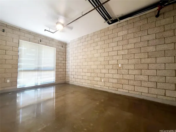 a view of a livingroom with an empty space and a window