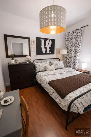 a bedroom with a bed and a table in it