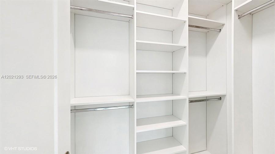 8350 Royal County Down Road Boca Raton, FL 33434 - Photo 16 of 52 a view of walk in closet with empty racks