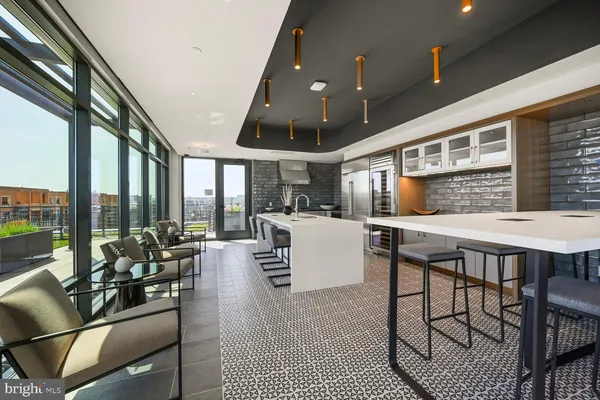 a kitchen with a large window and dining table