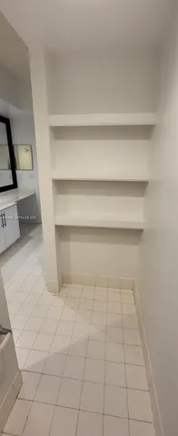 a living room with a rug and white walls
