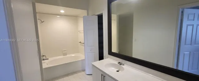 a bathroom with a tub and a sink