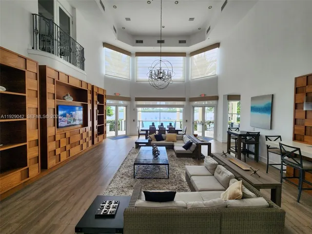 a view of living room kitchen with furniture and large windows