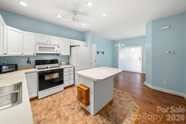 a kitchen with stainless steel appliances a stove a sink and a refrigerator