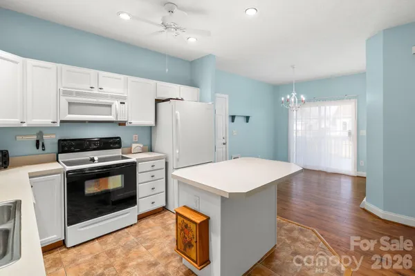a kitchen with stainless steel appliances a stove a refrigerator sink and cabinets