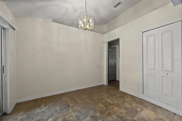a living room with lots of furniture and paintings on the wall