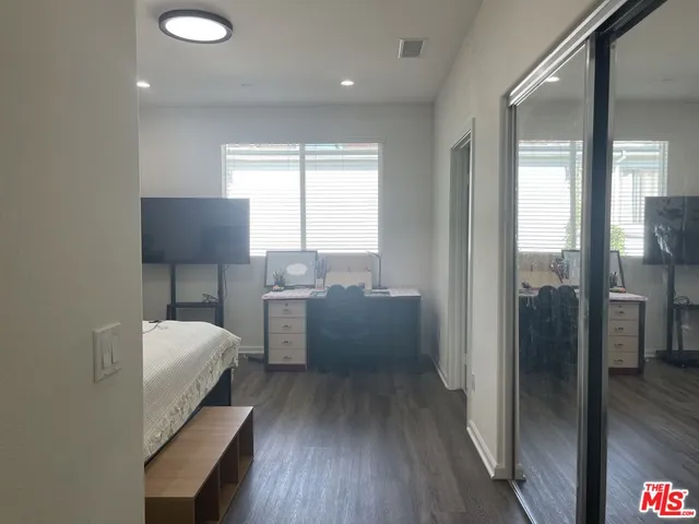a kitchen with a table chairs refrigerator and window