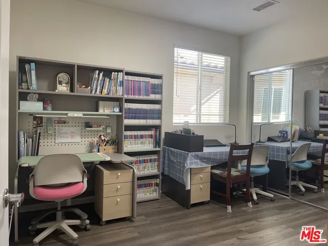 a work room with furniture and wooden floor