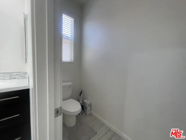 a bathroom with a toilet a sink and a window