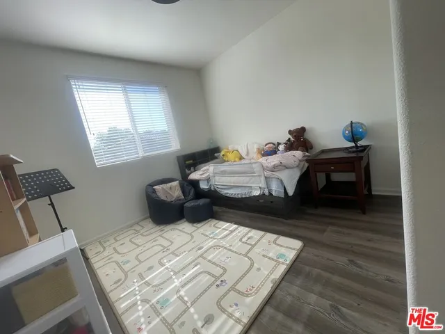 a bedroom with bed and a window