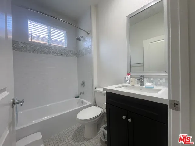 a bathroom with a sink toilet vanity and bathtub