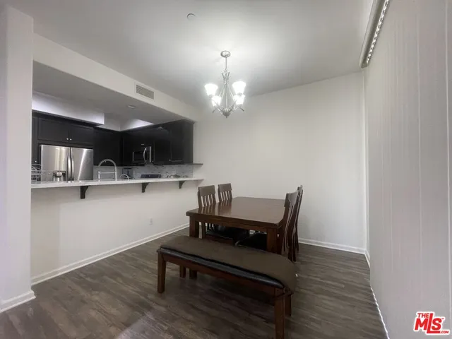 a living room with kitchen island furniture and a wooden floor