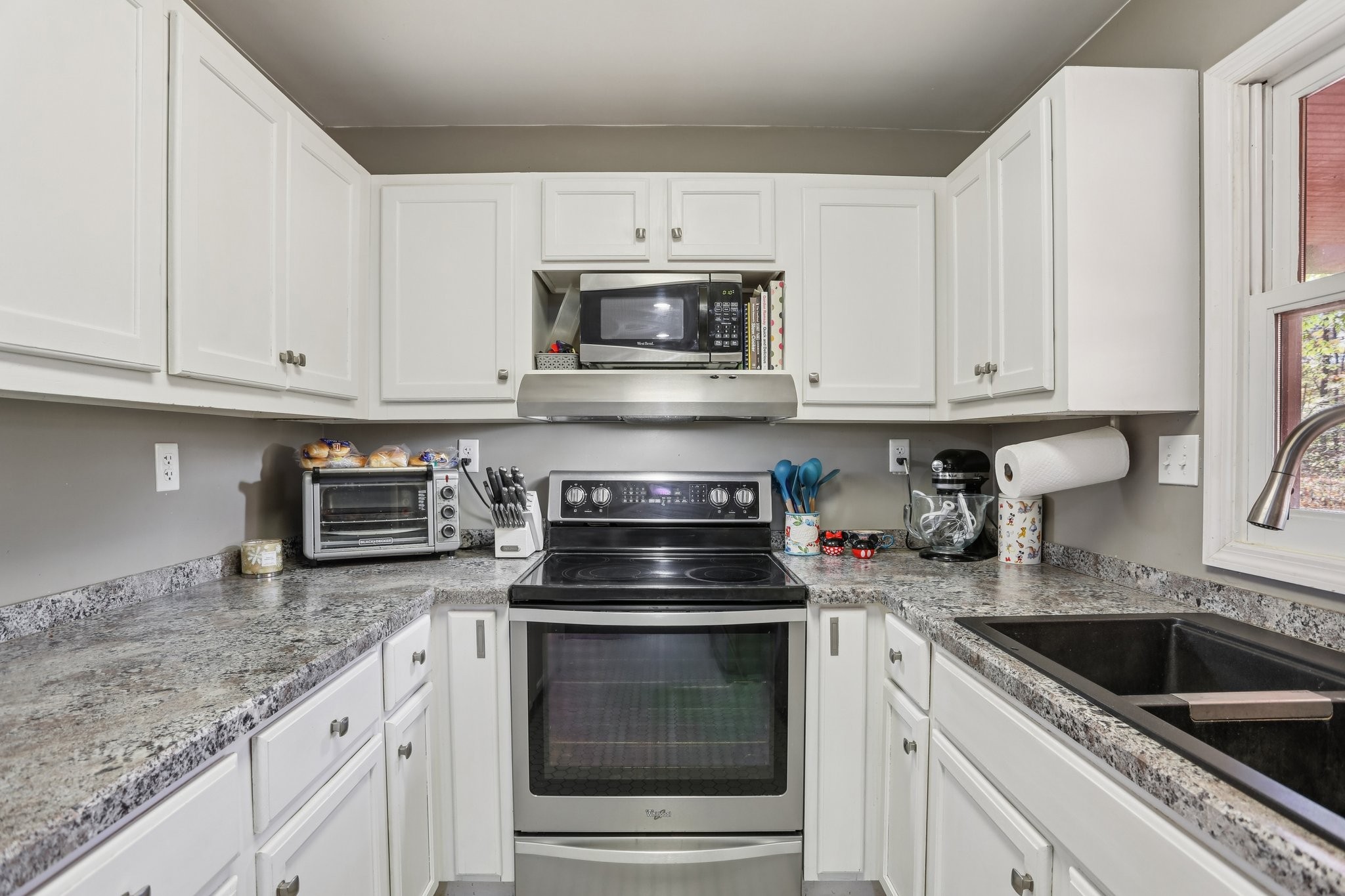 4515 C M Martin Road Springfield, TN 37172 - Photo 17 of 27 a kitchen with granite countertop white cabinets and stainless steel appliances