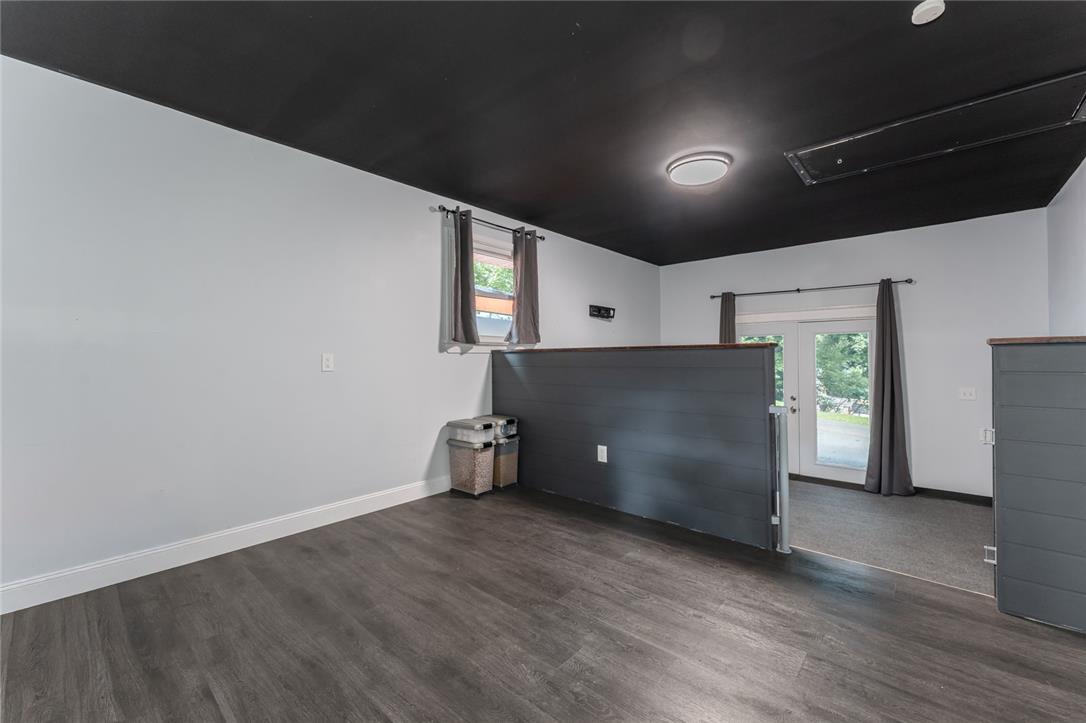 402 Maple Street Roseto, PA 18013 - Photo 28 of 39 Dark wood-look flooring contrasts beautifully with a dramatic dark ceiling in this versatile bonus space.