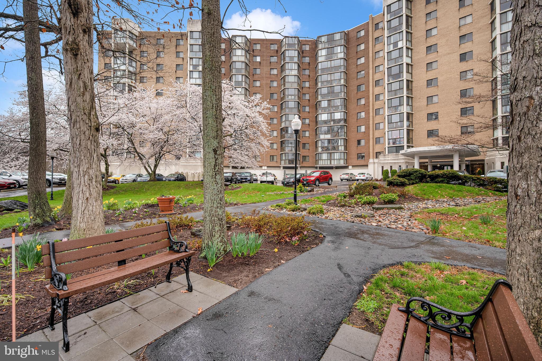 a backyard of a residential building with barbeque oven table and chairs
