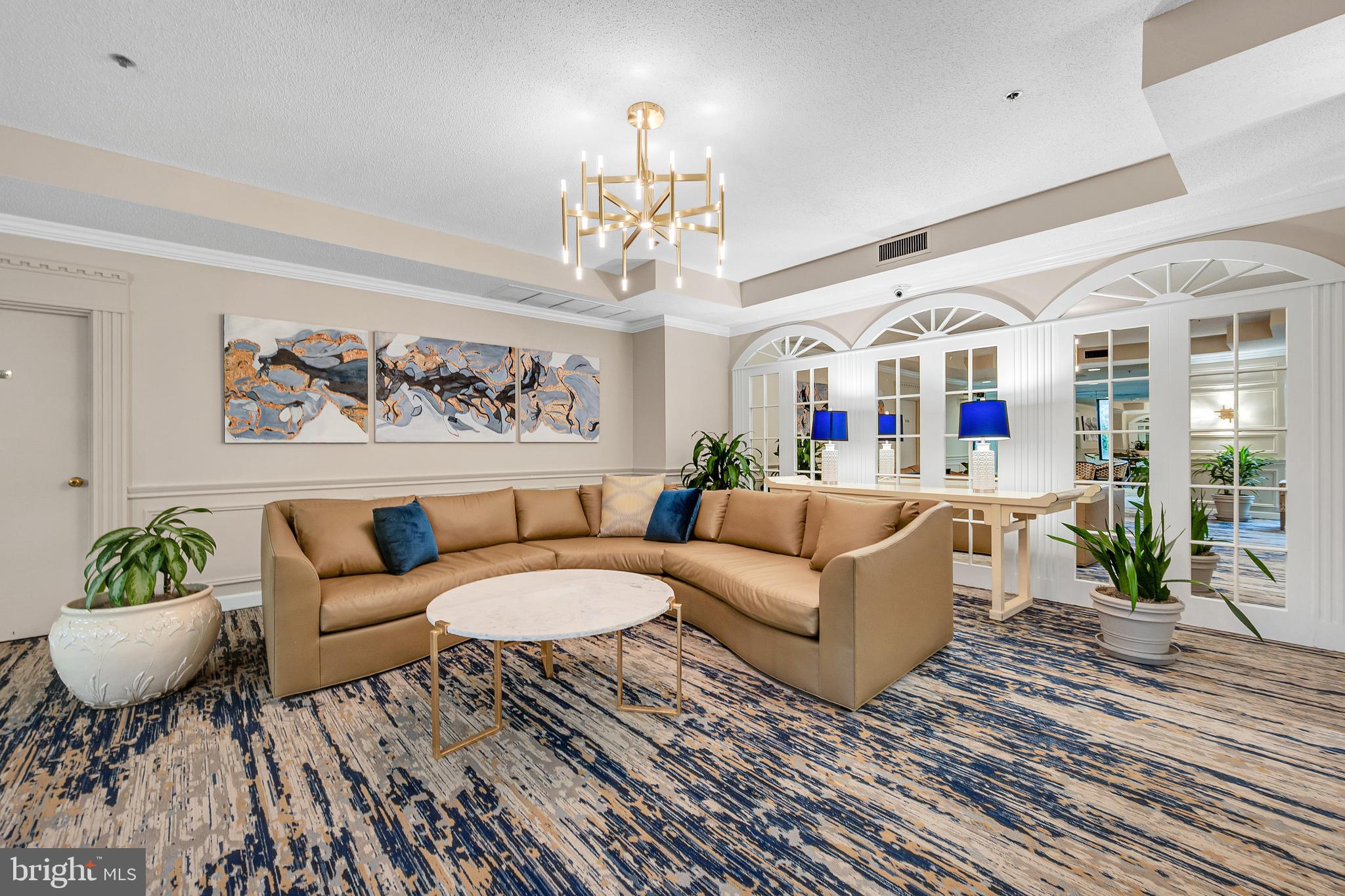 15101 Interlachen Drive, Unit 1126 Silver Spring, MD 20906 - Photo 22 of 32 a living room with furniture and a chandelier