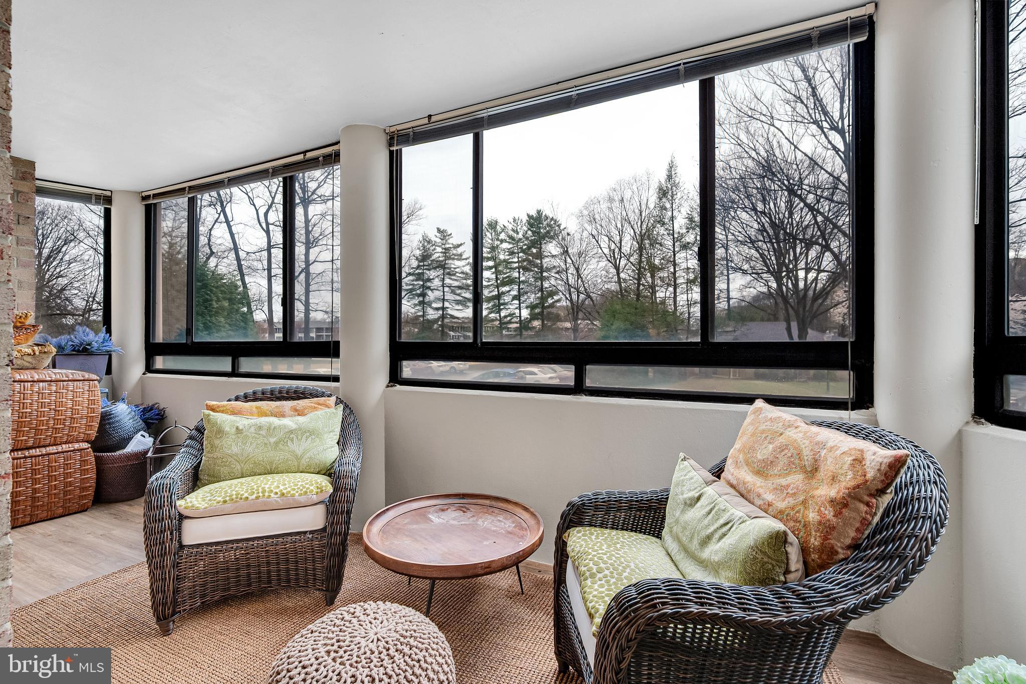 15101 Interlachen Drive, Unit 1126 Silver Spring, MD 20906 - Photo 10 of 32 a living room with furniture and a large window