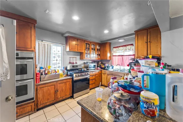 a kitchen with a sink a stove and a refrigerator