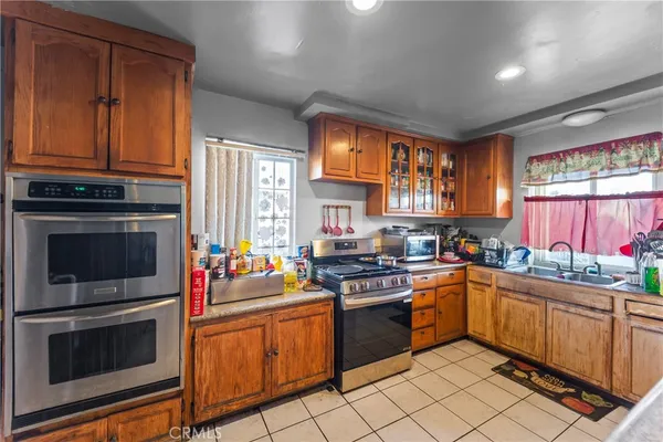 a kitchen with a stove a sink dishwasher and a microwave oven with cabinets
