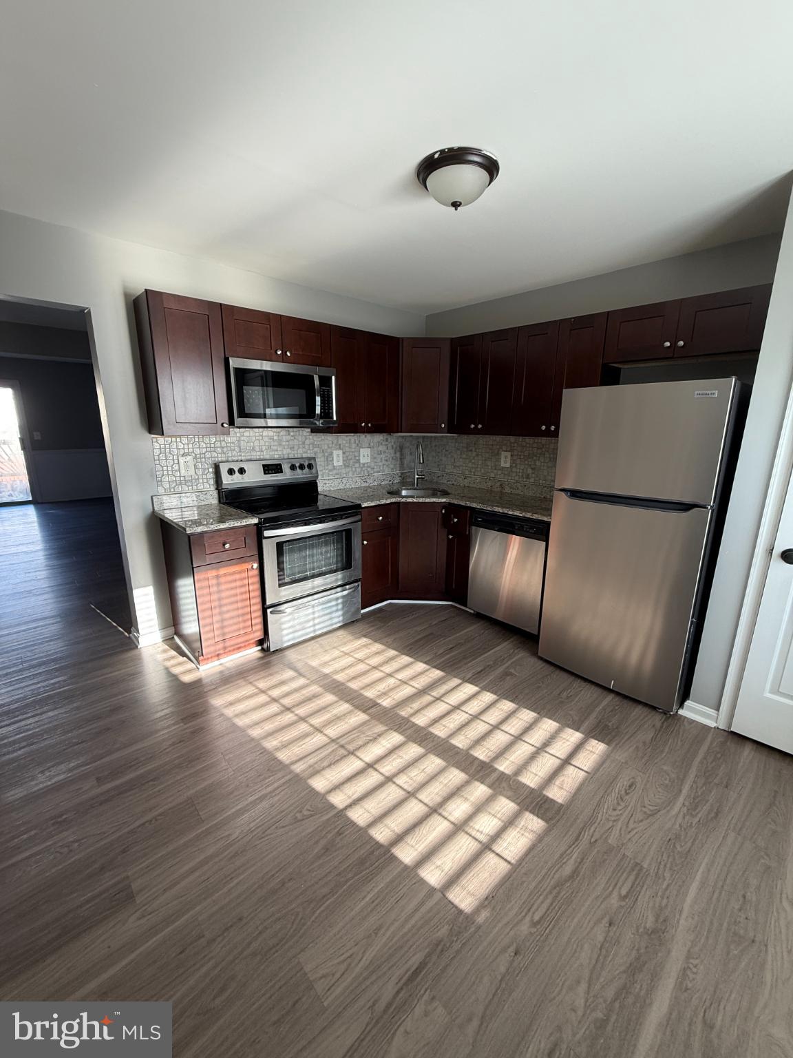 1027 Pirates Court Edgewood, MD 21040 - Photo 2 of 21 a kitchen with stainless steel appliances granite countertop a stove top oven a sink and a microwave