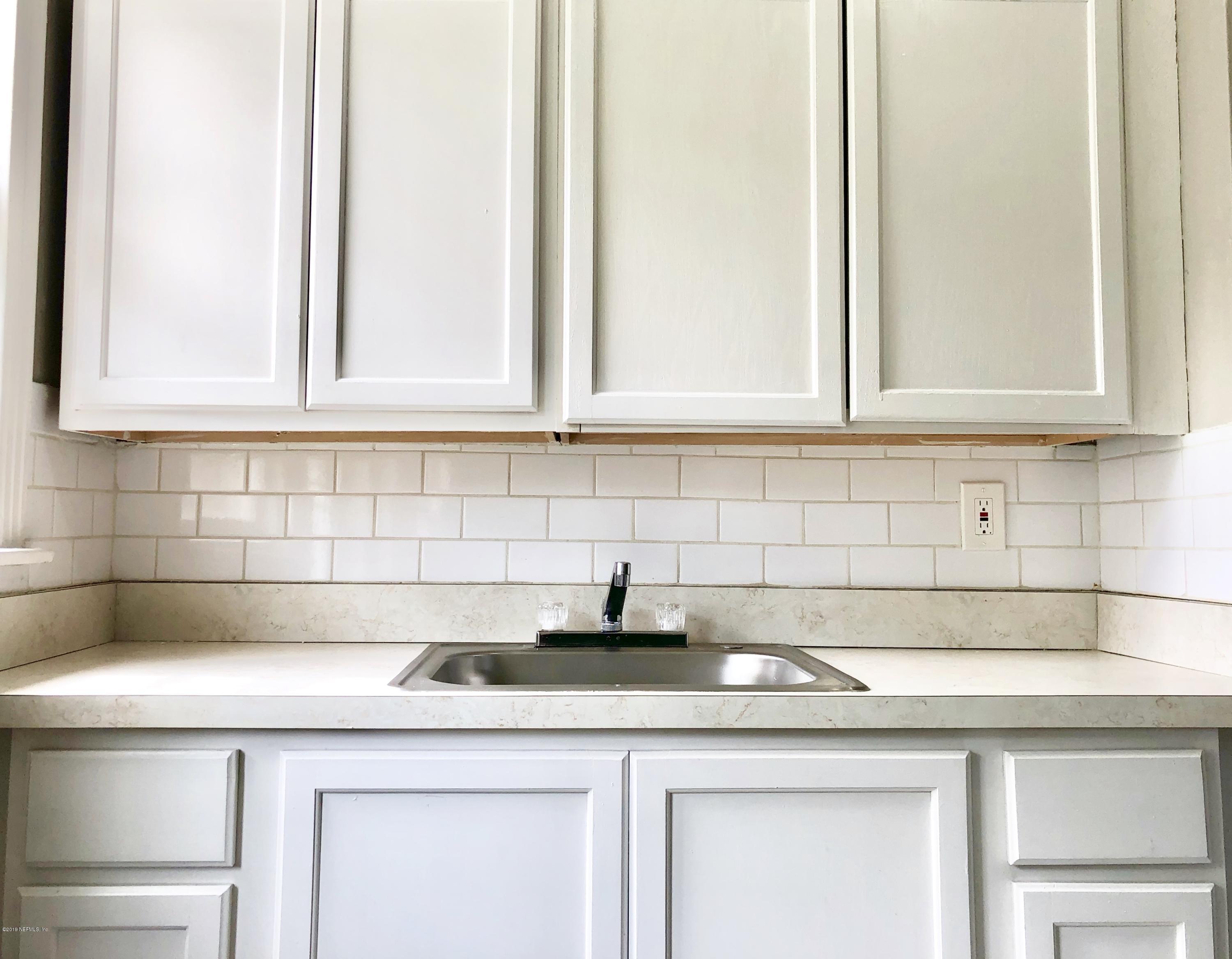5146 Sunderland Road Jacksonville, FL 32210 - Photo 2 of 10 a kitchen with a sink and cabinets