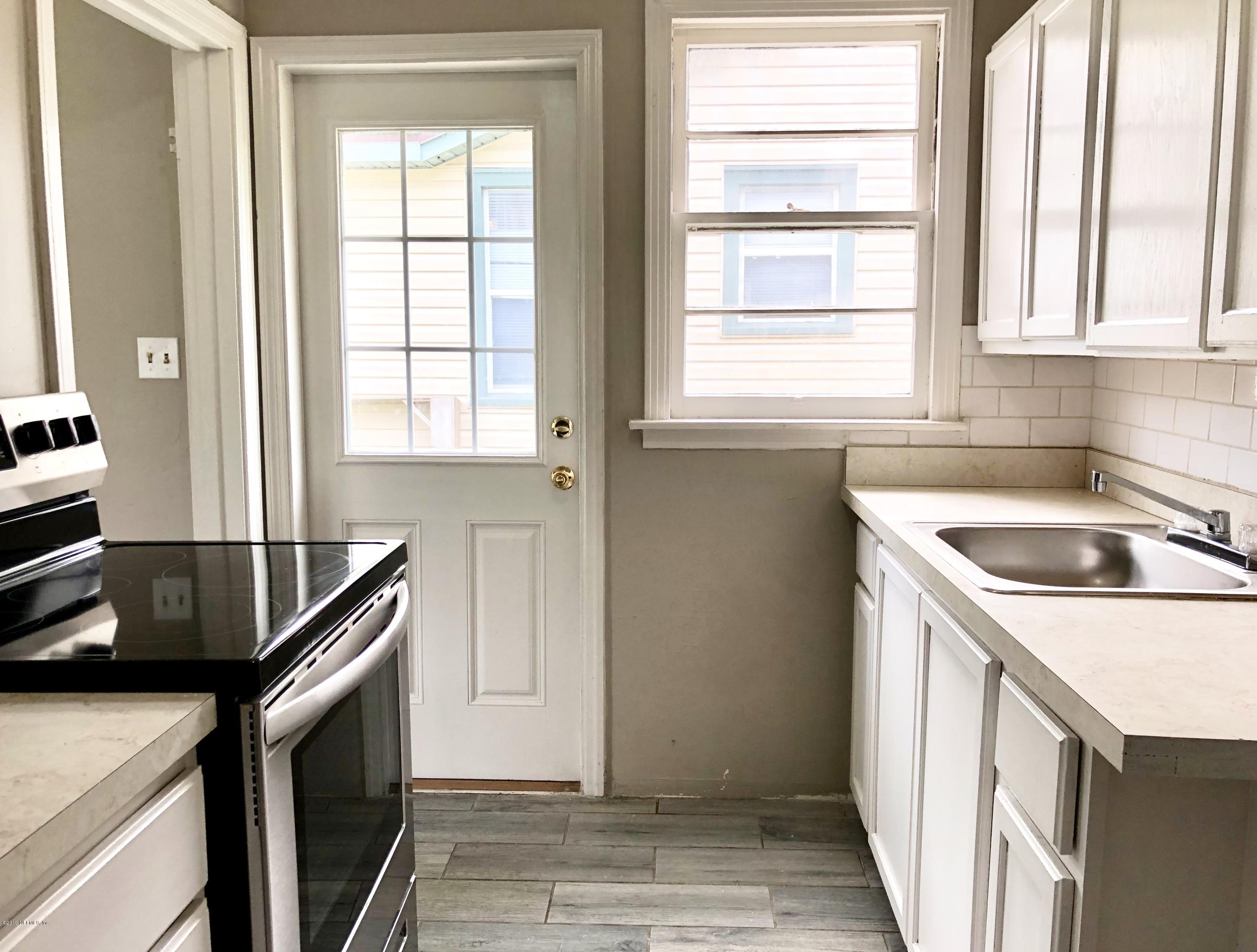 5146 Sunderland Road Jacksonville, FL 32210 - Photo 3 of 10 a kitchen with a sink a stove and a window